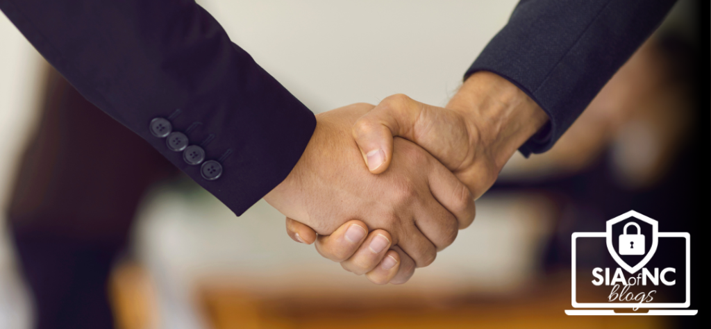 Episode #31: The Evolution of Existing Agencies: Is It Time to Partner? two men shaking hands across a table like a deal was made.