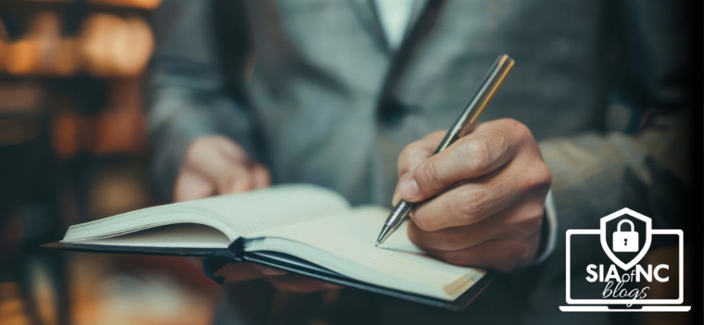 Independent insurance agent writing notes in a journal, representing how to write business in other states – SIA of NC Blogs